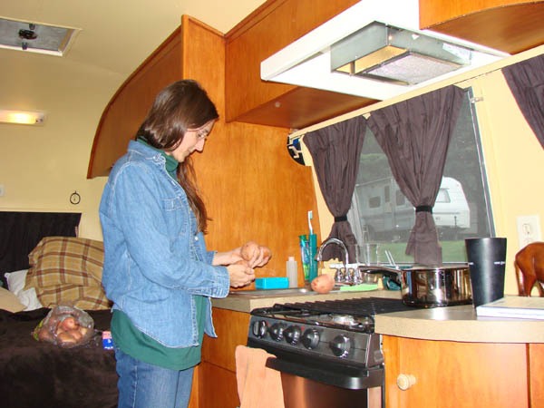 Chloe cooking in the Airstream.