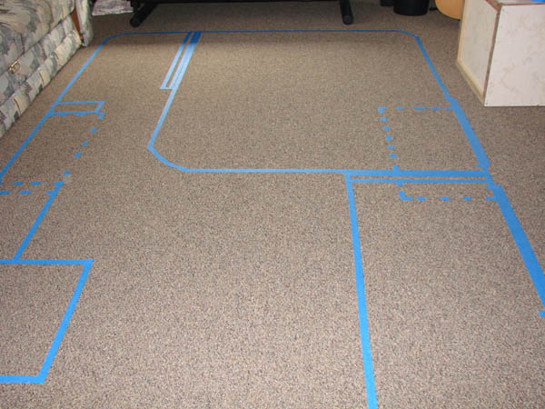 Front side of camper layout taped onto the floor.