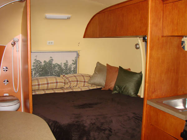 Bed area and overhead cabinets.