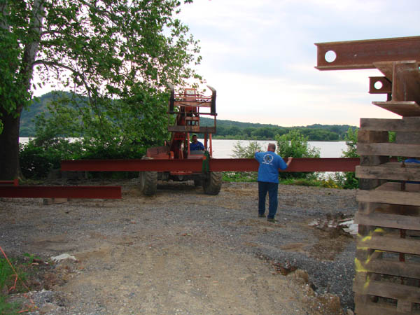 Bob Arney guiding the new steel beam.