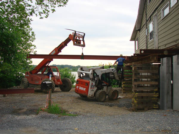 Lifting the beam to get it under the house.