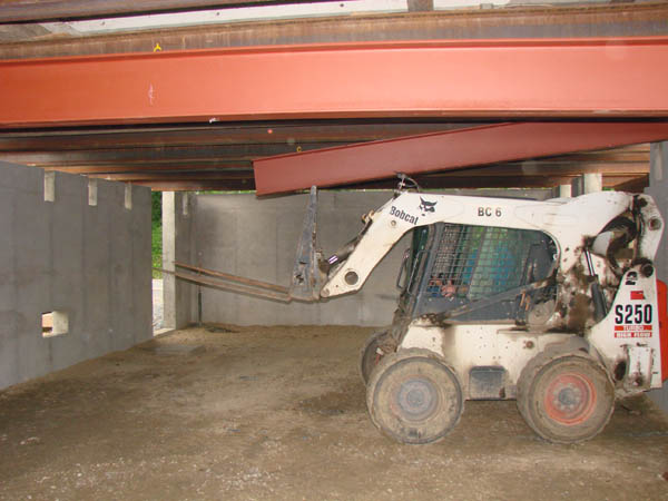 Guiding the beam into place from under the house.