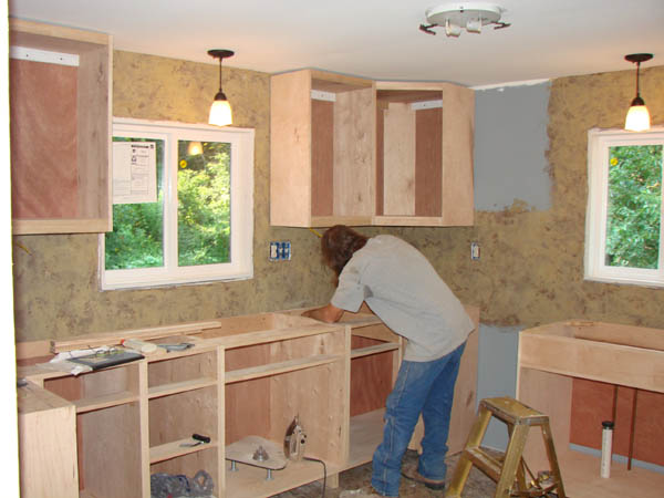 Ren installing cabinets.