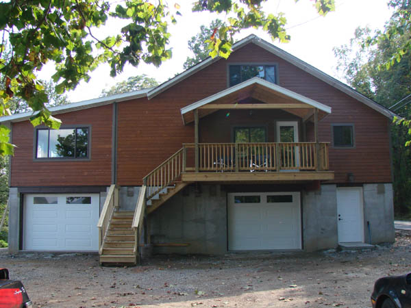 Front with siding and deck.